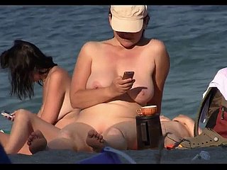 Cheeky nudist babes sunbathing on a difficulty coast on overhear cam